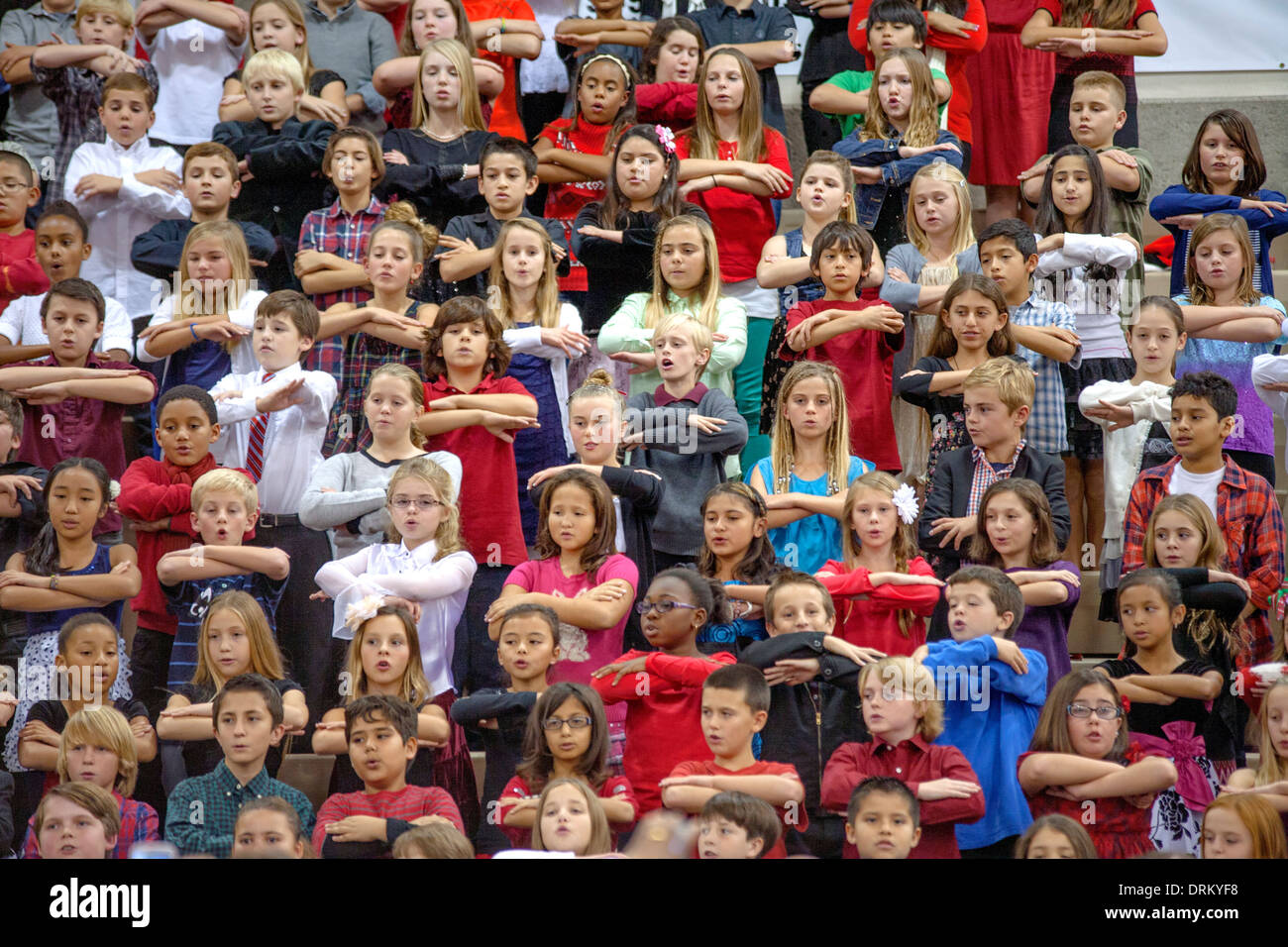 Multiracial middle school children sing Christmas carols as a group at a school concert in Aliso Viejo, CA Stock Photo