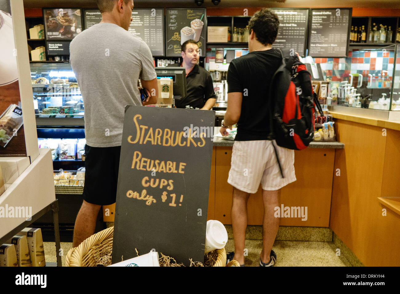 Miami Beach Florida,Starbucks Coffee,barista,interior inside,man men male,customer,employee worker workers working staff,counter,ordering,FL140122008 Stock Photo