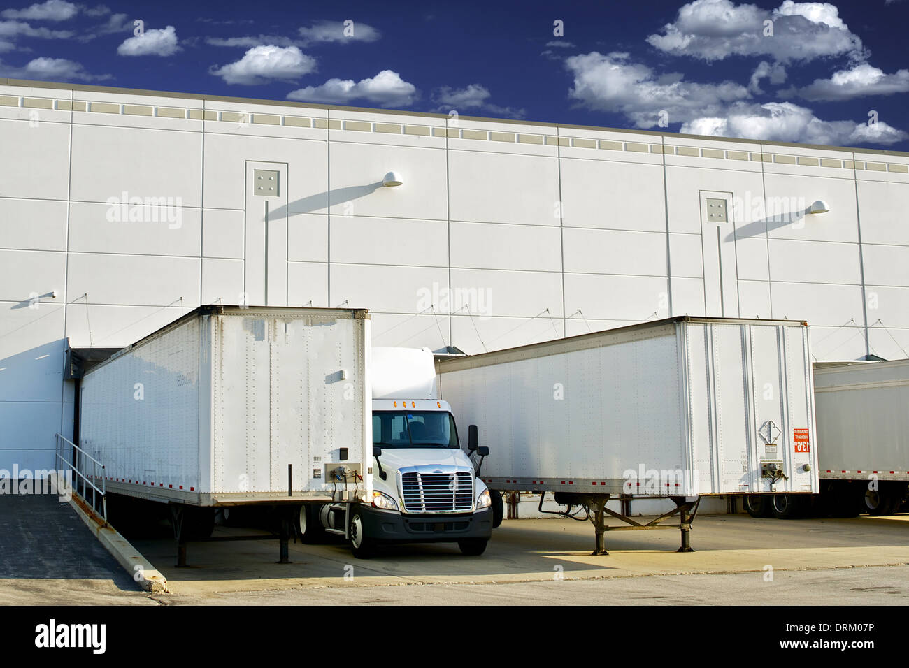 Warehouse Loading Docks - Business District. Semi Trucks and Trailers Loading. Shipping and Logistics Photography Collection. Stock Photo