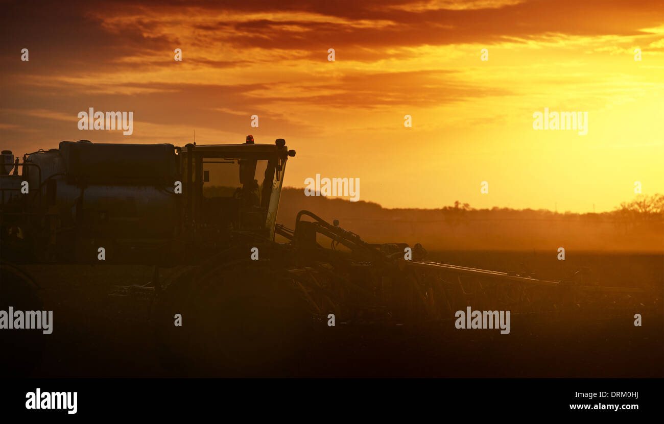 Cultivating in Sunset. Tractor Works on the Field. Agriculture Works Photography Collection. Stock Photo