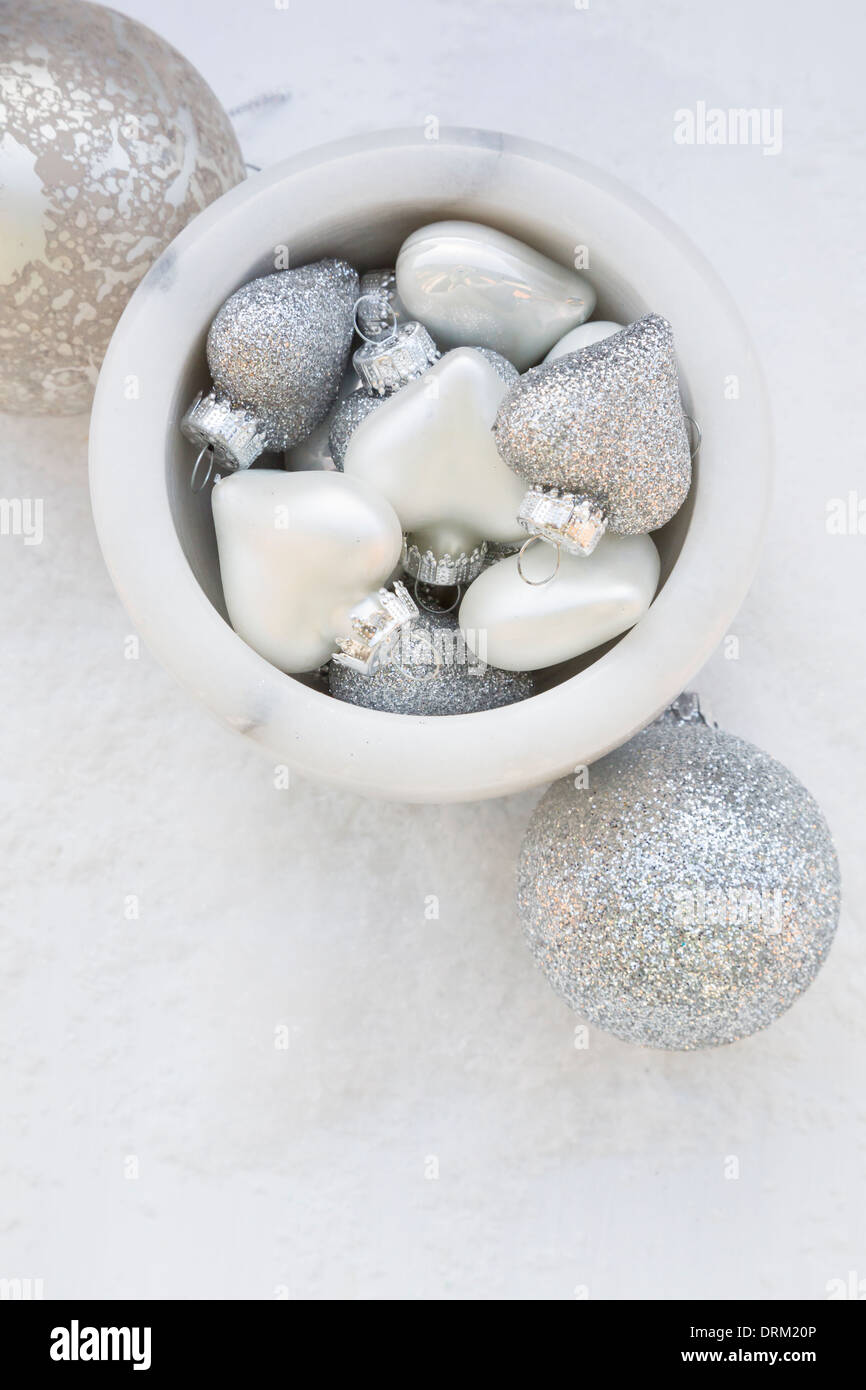 Silver christmas baubles in the snow hi-res stock photography and ...