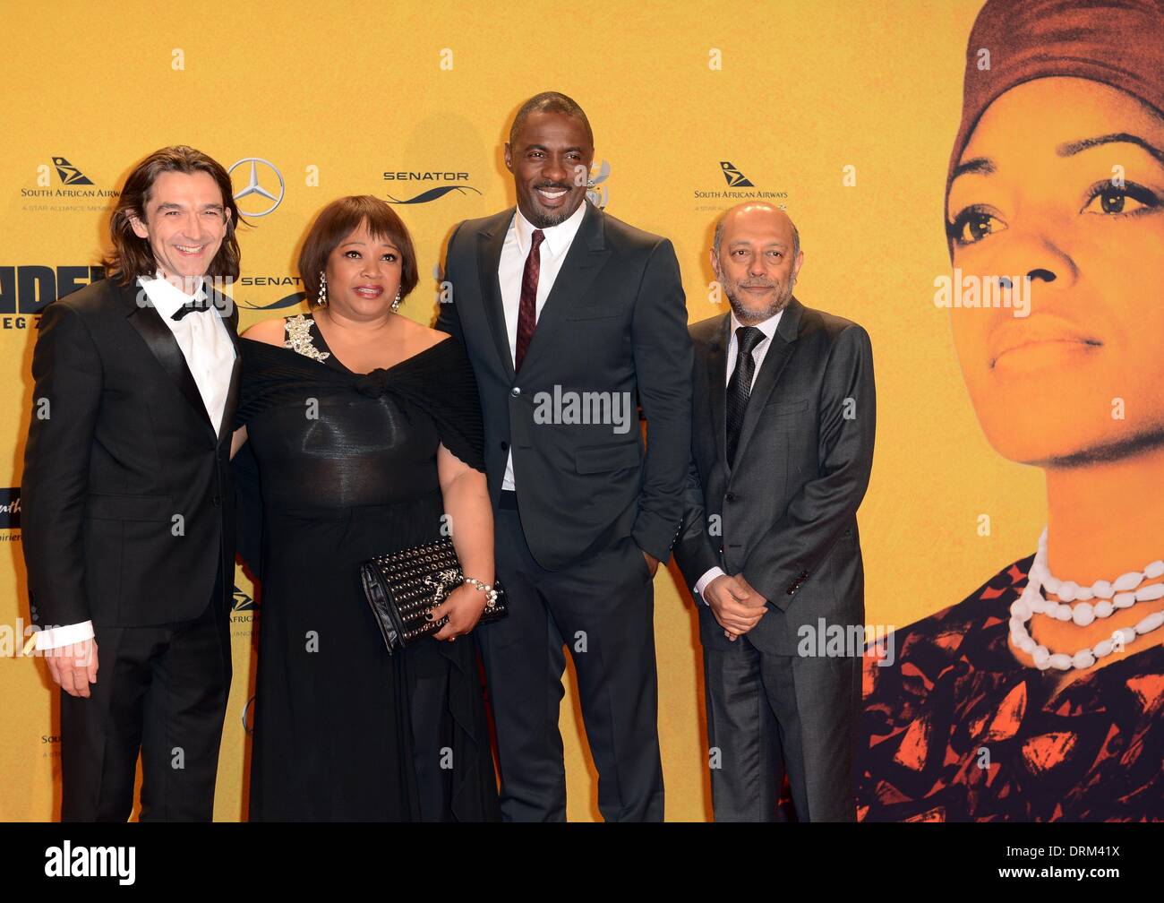 Berlin, Germany. 28th Jan, 2014. Film director Justin Chadwick (L-R), the daughter of South Africa's former President Nelson Mandela, Zindzi Mandela, the lead actor Idris Elbaand producer Anant Singh arrive for the German premiere of the film 'Mandela - The long way to Freedom' in Berlin, Germany, 28 January 2014. The film will start in german cinemas on 30 January 2013. Photo: Britta Pedersen/dpa/Alamy Live News Stock Photo
