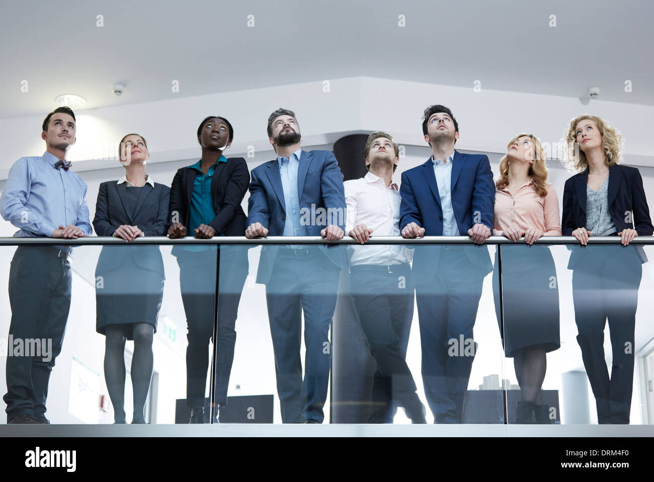 People Standing Behind Railing Germany, Neuss, Group of business people standing behind railing ...