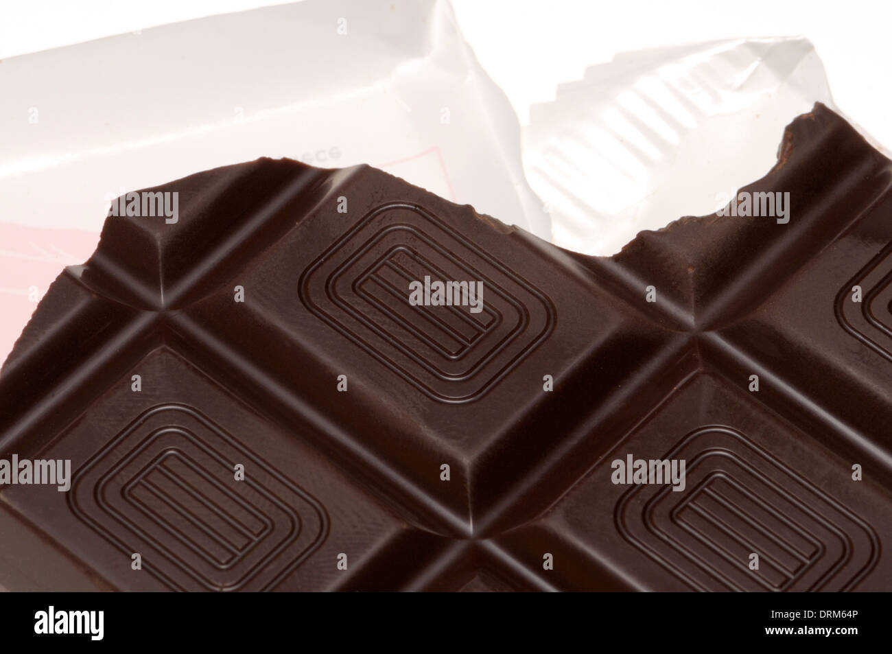 Bar of dark chocolate in wrapper Stock Photo