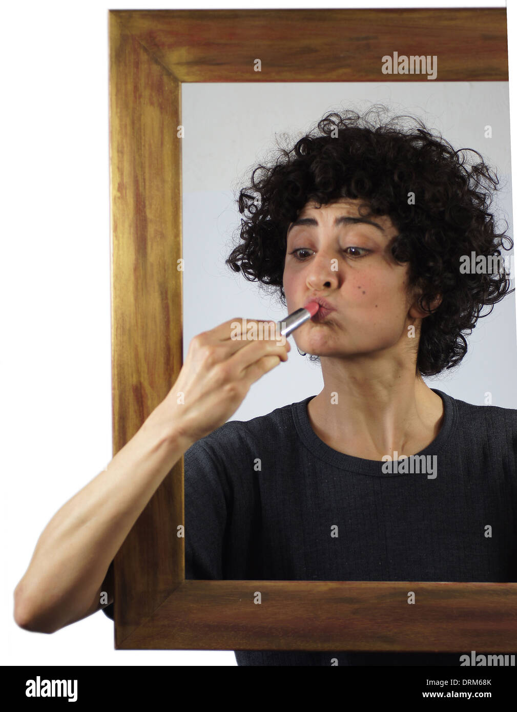 Woman put lipstick on Stock Photo - Alamy