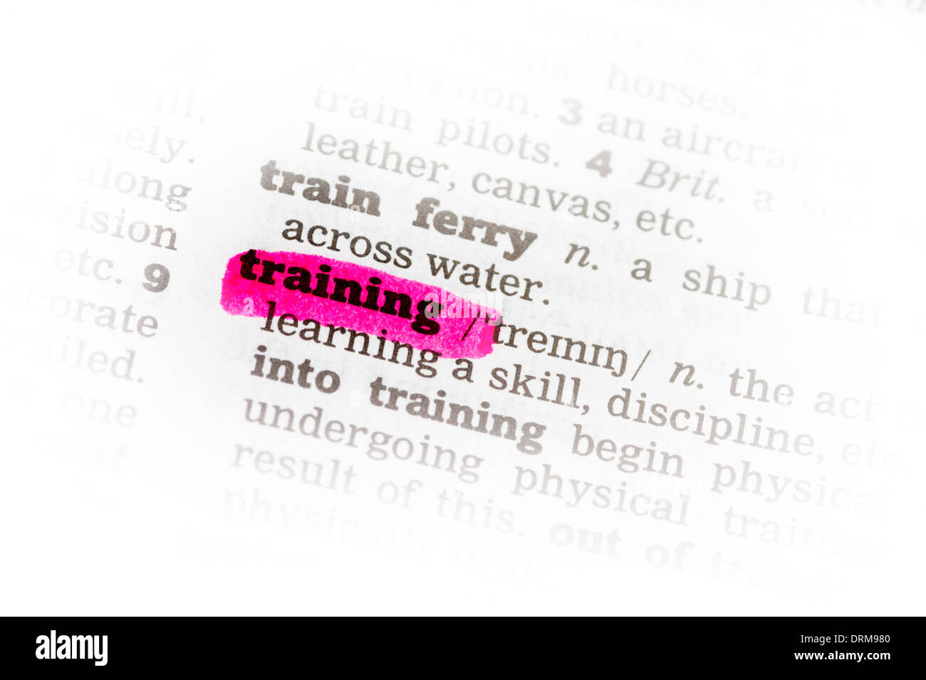 Training Dictionary Definition highkighted in pink marker Stock Photo