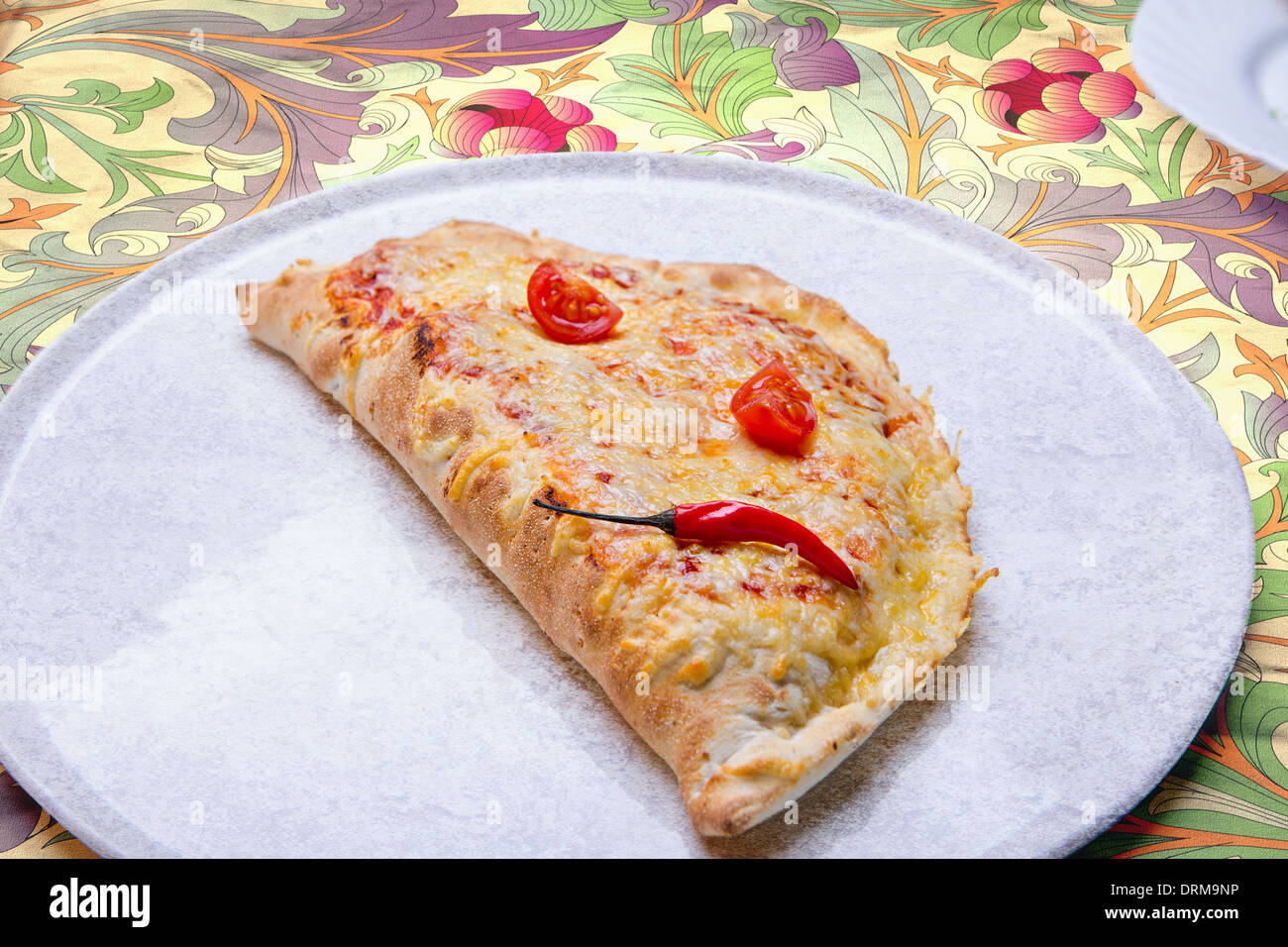 close up shot of Pizza calzone on the plate Stock Photo