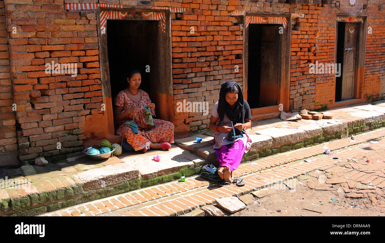 KATHMANDU, NEPAL - JUNE 2013: local women knitting at street Stock Photo