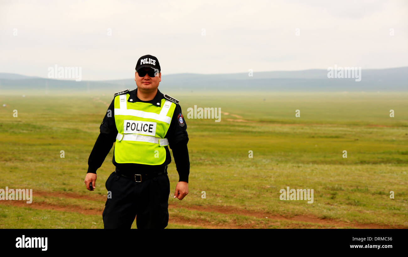 ULAANBAATAR, MONGOLIA - JULY 2013: Police officer at mongolian grassland Stock Photo