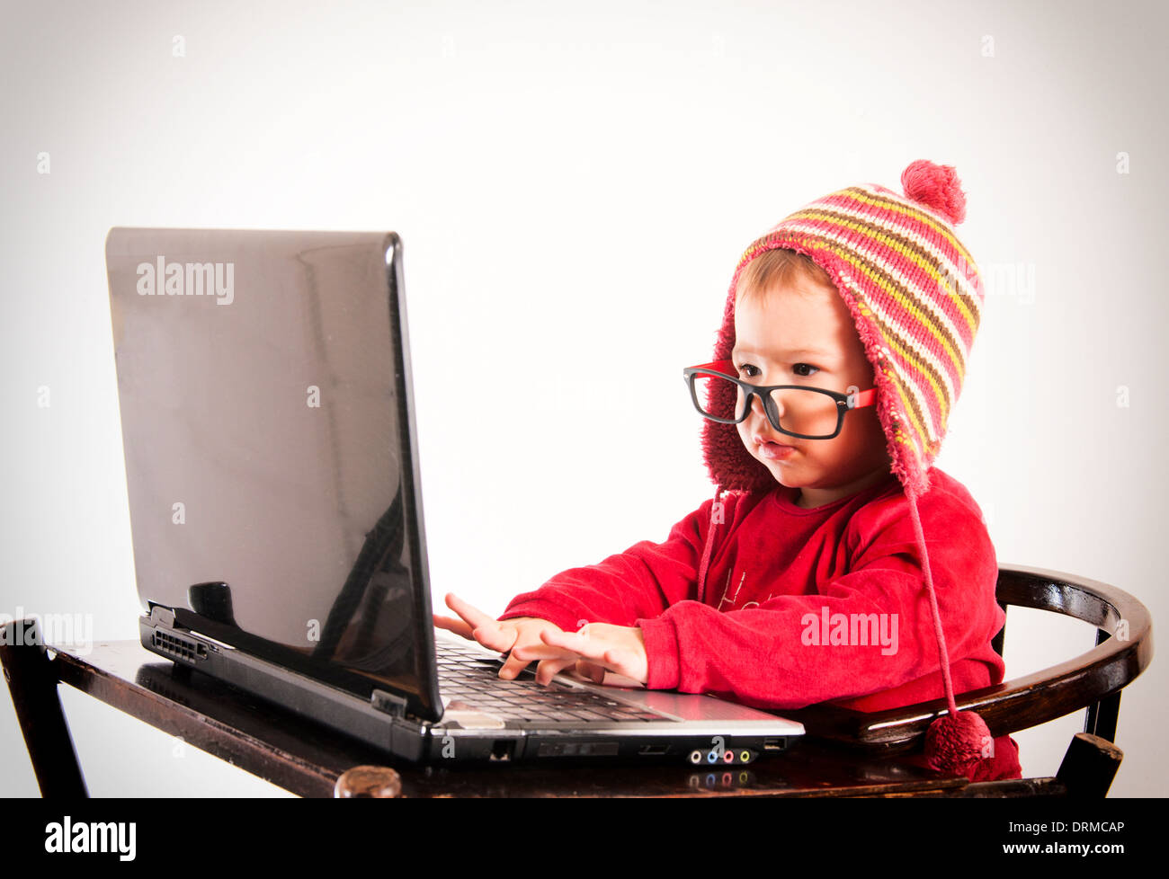 Little baby hacker typing on the laptop compiuter Stock Photo Alamy