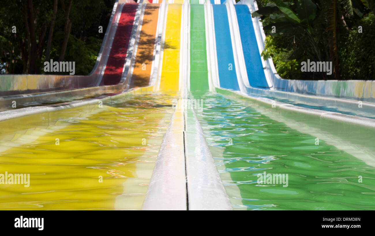 Rainbow colored water slide summer fun Stock Photo