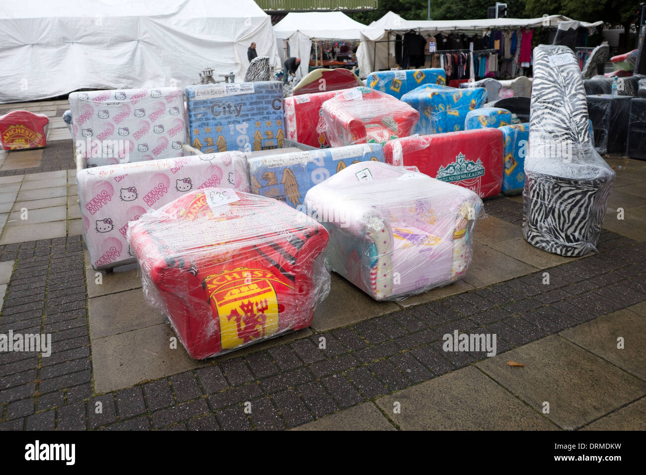 New furniture covered in plastic protect from rain Stock Photo Alamy