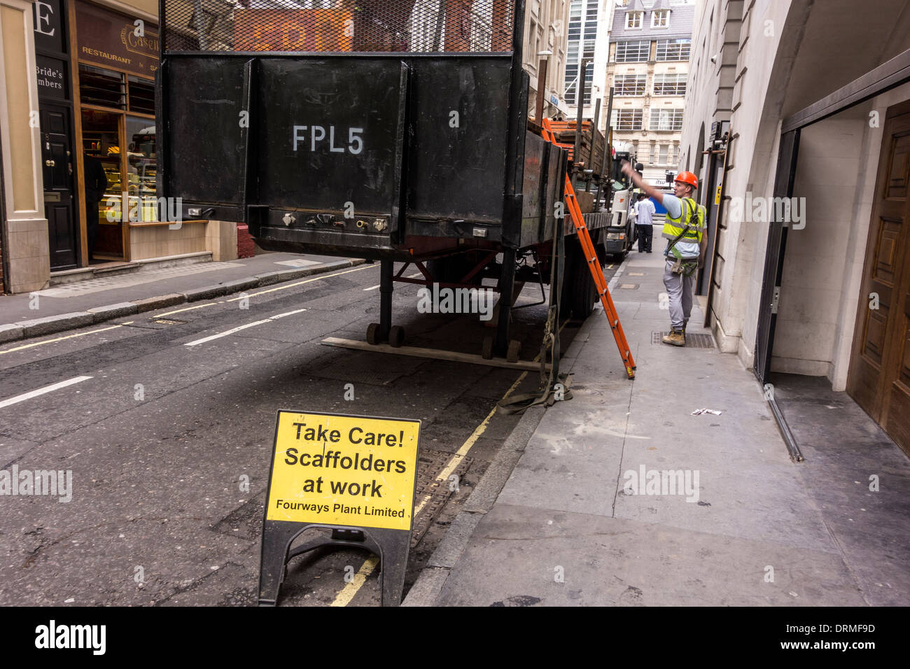 Scaffolders' safety warning sign on street, London, UK Stock Photo