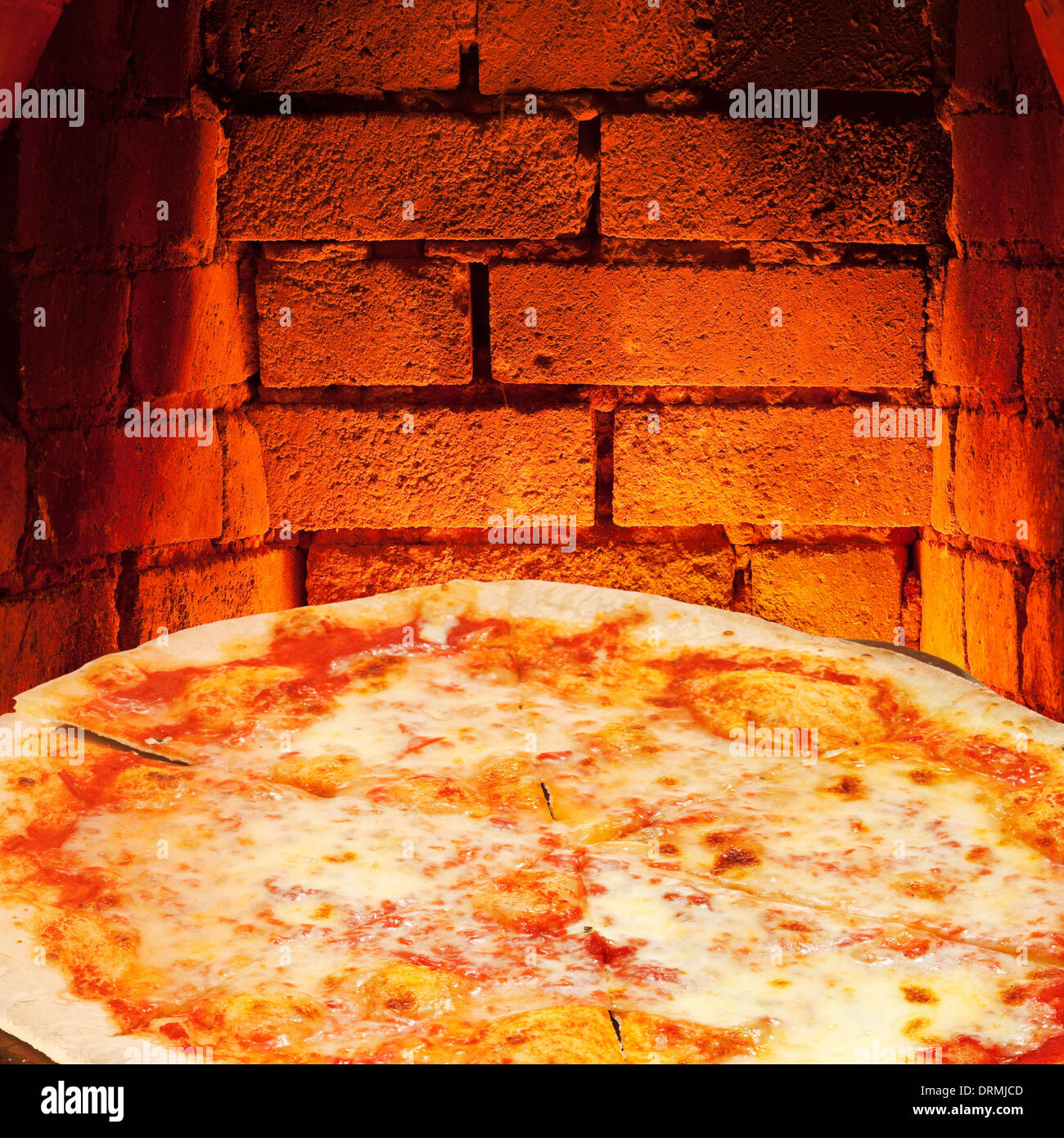 italian pizza margherita and hot brick wall of wood burning oven Stock Photo