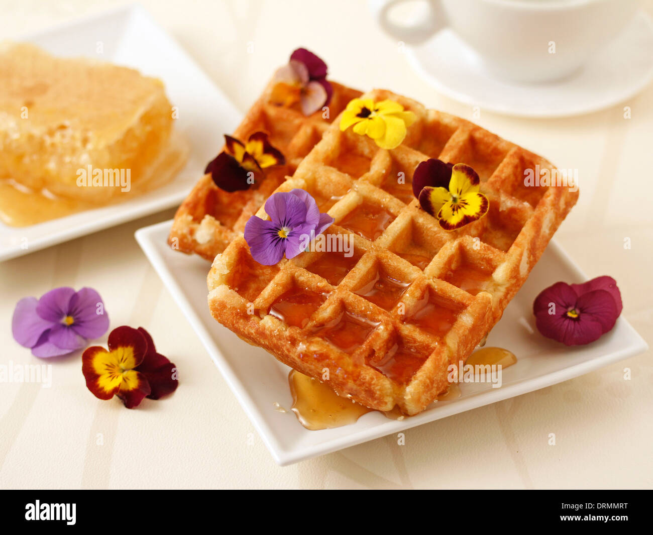 Waffles with honey and flowers. Recipe available. Stock Photo