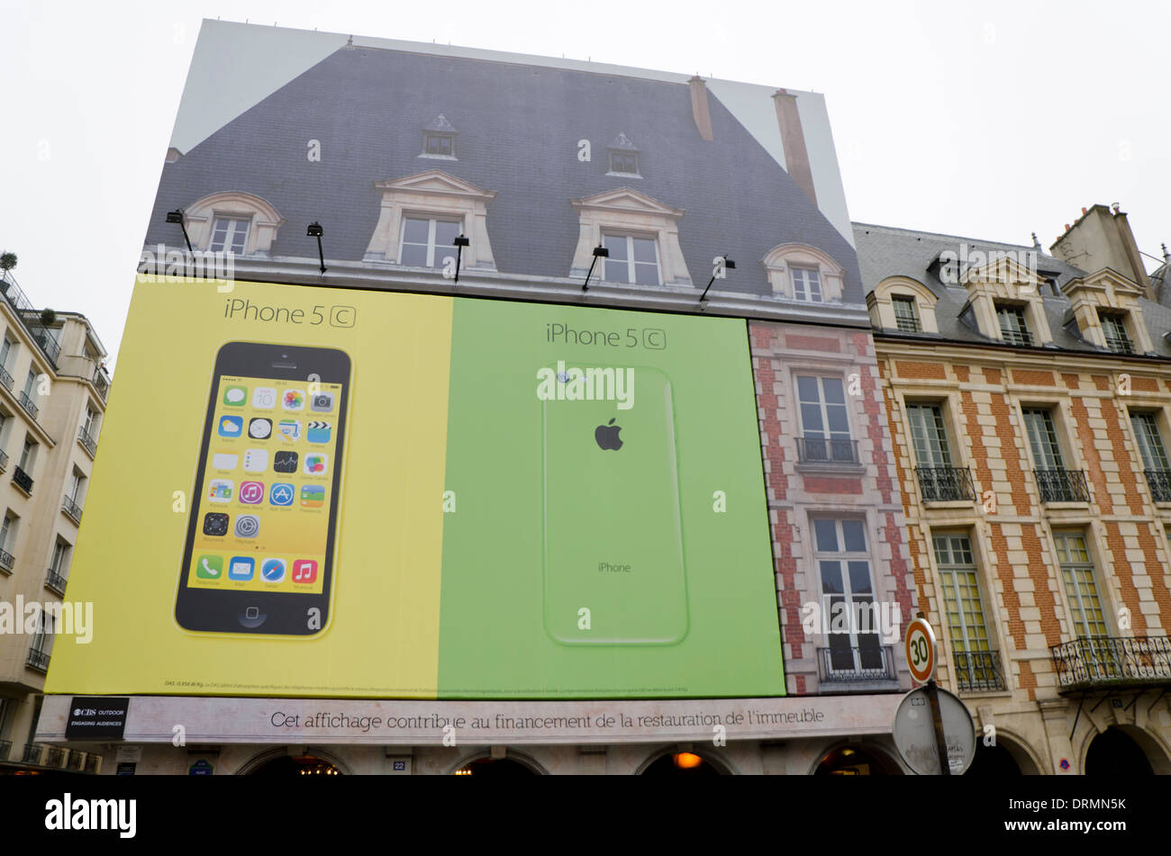 Billboard of iphone 5 covering building as financial sponsorship for reconstruction Place de vosges, Paris, France. Stock Photo