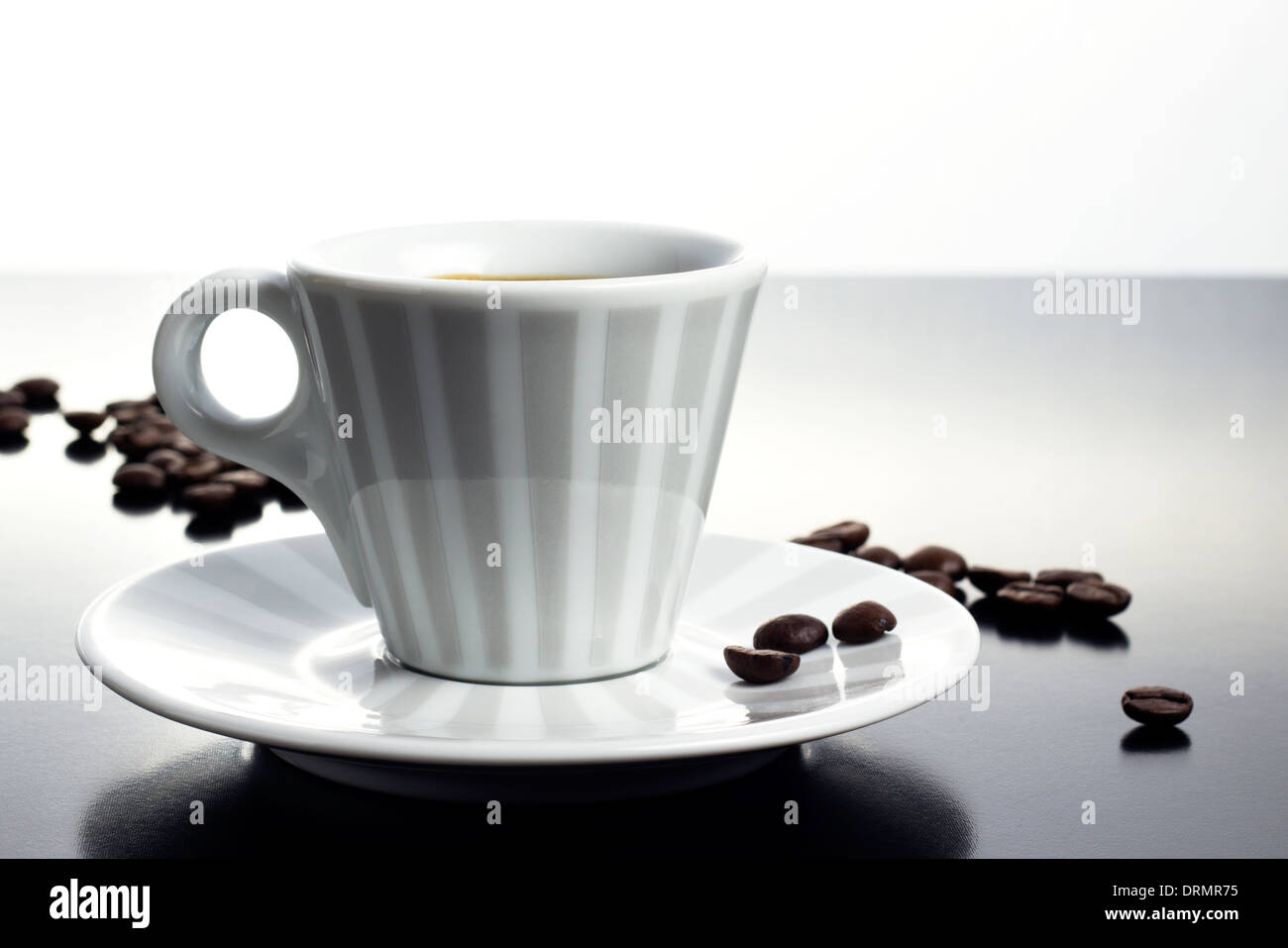 coffee cup with roasted beans on table Stock Photo