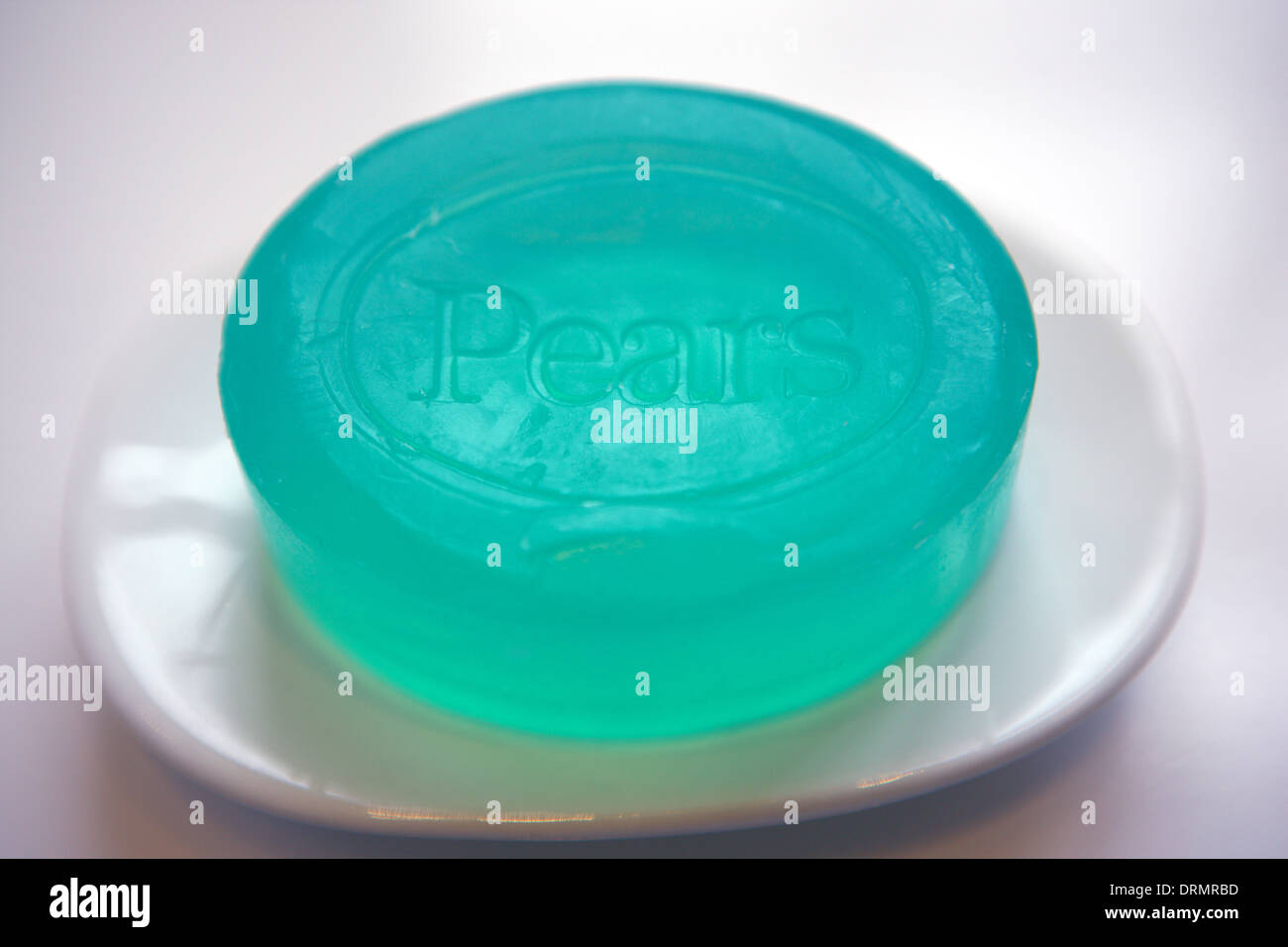 Pears green soap on a white soap dish Stock Photo - Alamy