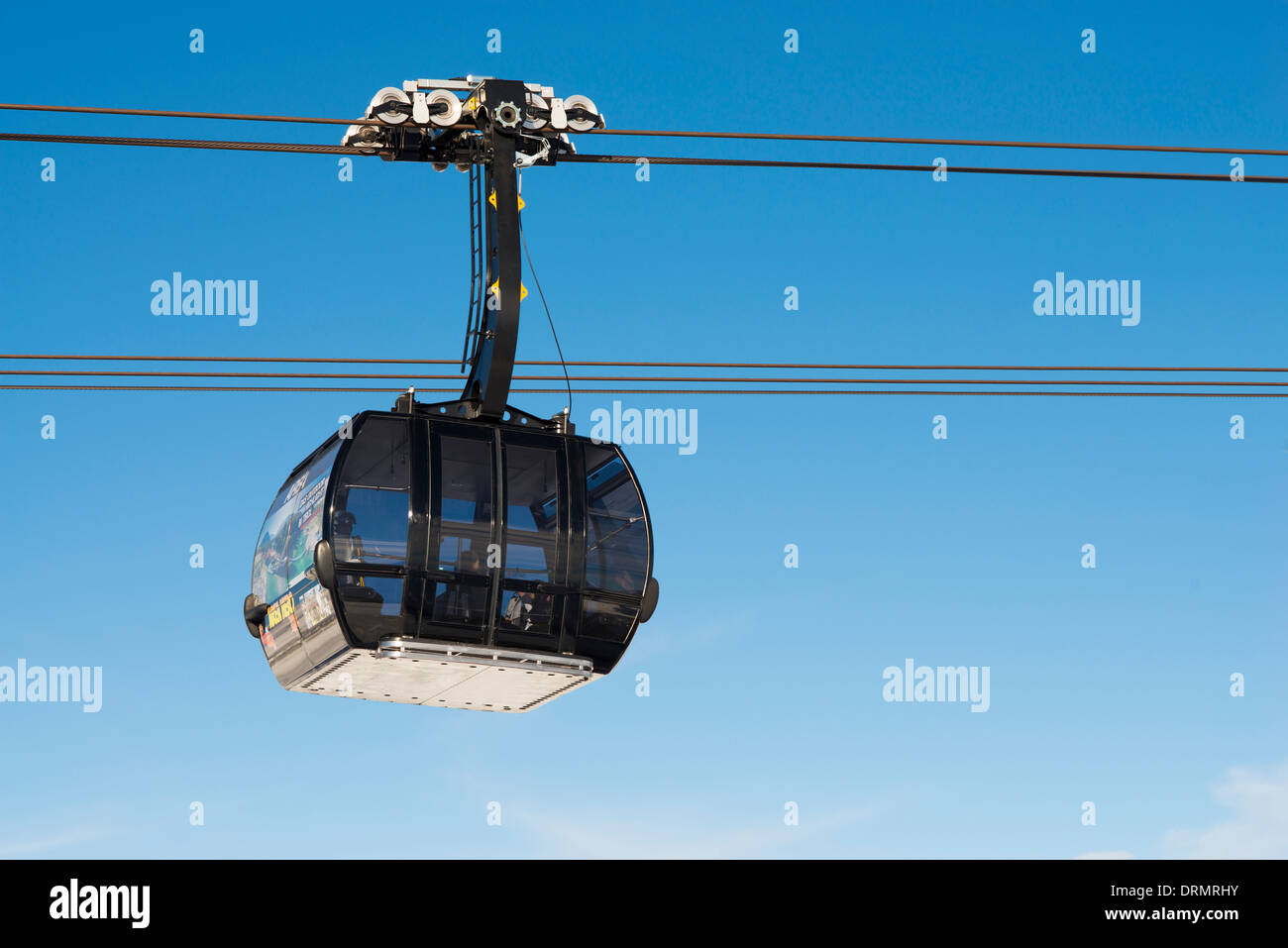 Cable car transporting skiers Stock Photo