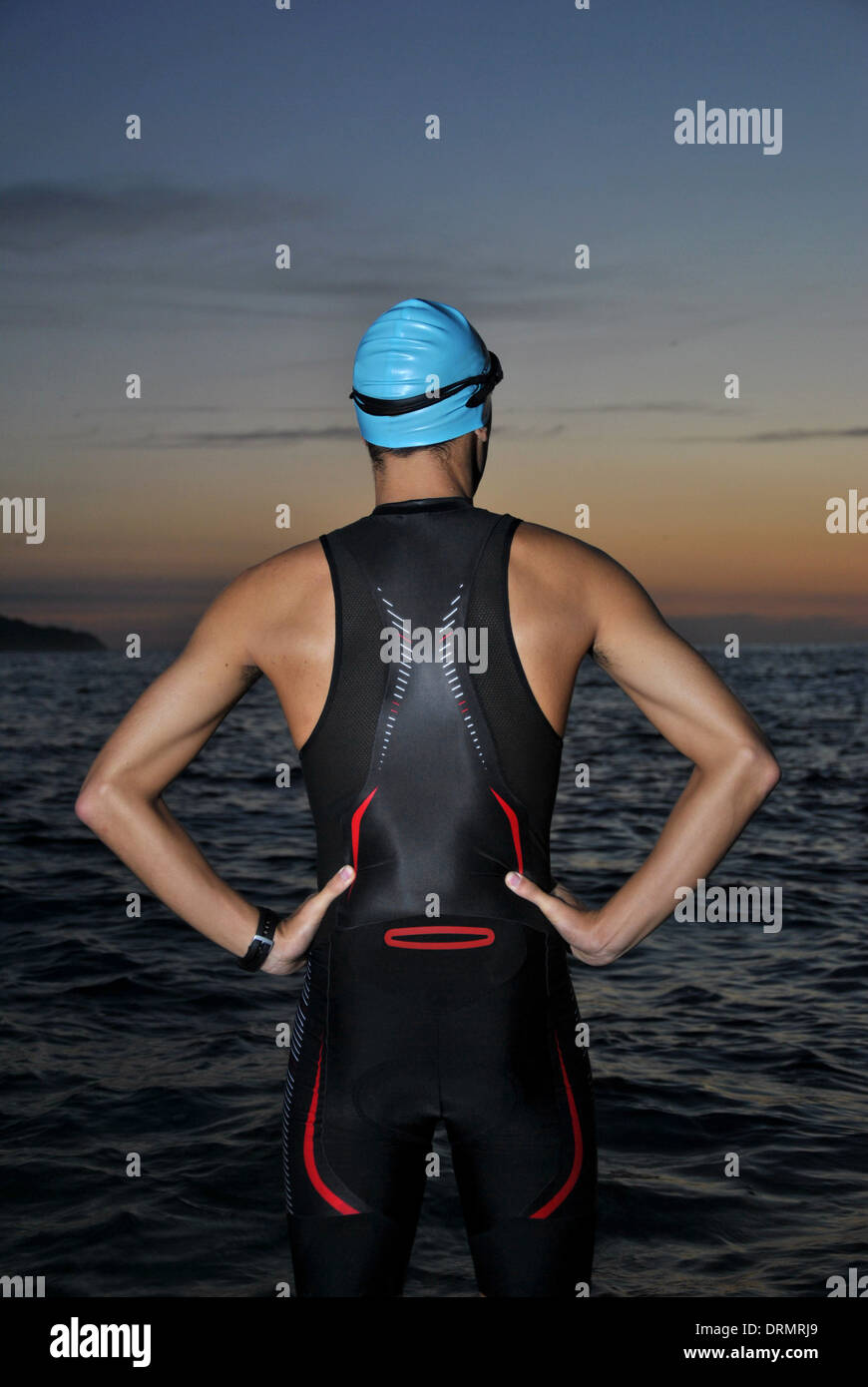 young athlete triathlon in front of a sunrise over the sea Stock Photo