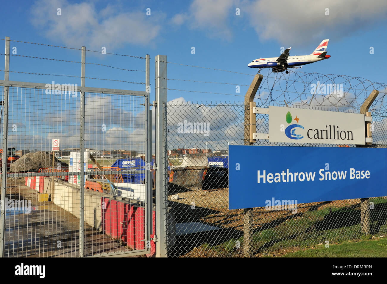 Carillion work in progress towards the expanded 'Snow Base' at London Heathrow Airport. Prompted by the severe winter weather of 2010. Plane landing Stock Photo