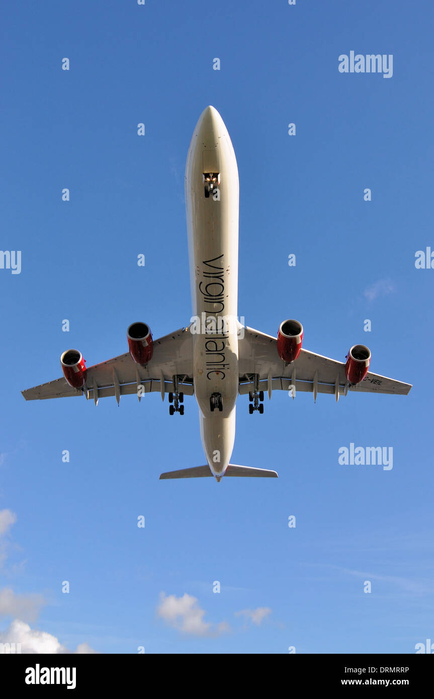 Virgin Atlantic Airbus A340 G-VEIL coming in to land at London Heathrow airport in blue sky Stock Photo