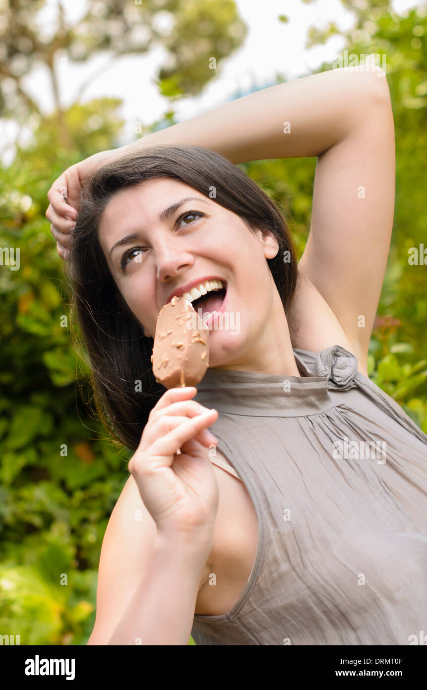 Beautiful young woman eating ice cream Stock Photo