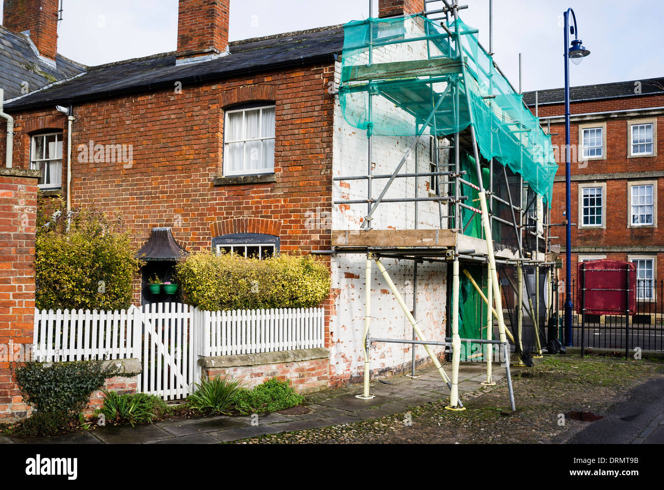 Maintenance on end wall and brick chimney stack of old town house in UK Stock Photo