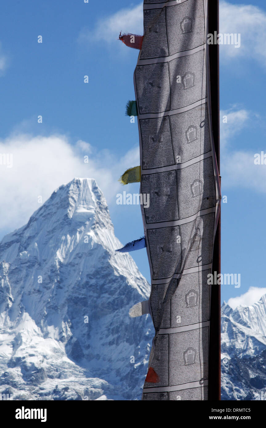 A prayer flag in the village of Khumjung on the everest base camp trek with Ama Dablam beyond Stock Photo