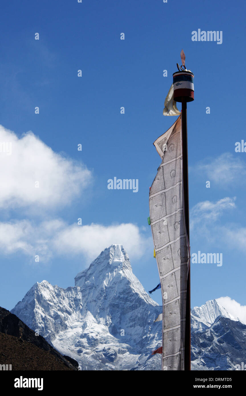 A prayer flag in the village of Khumjung on the everest base camp trek with Ama Dablam beyond Stock Photo