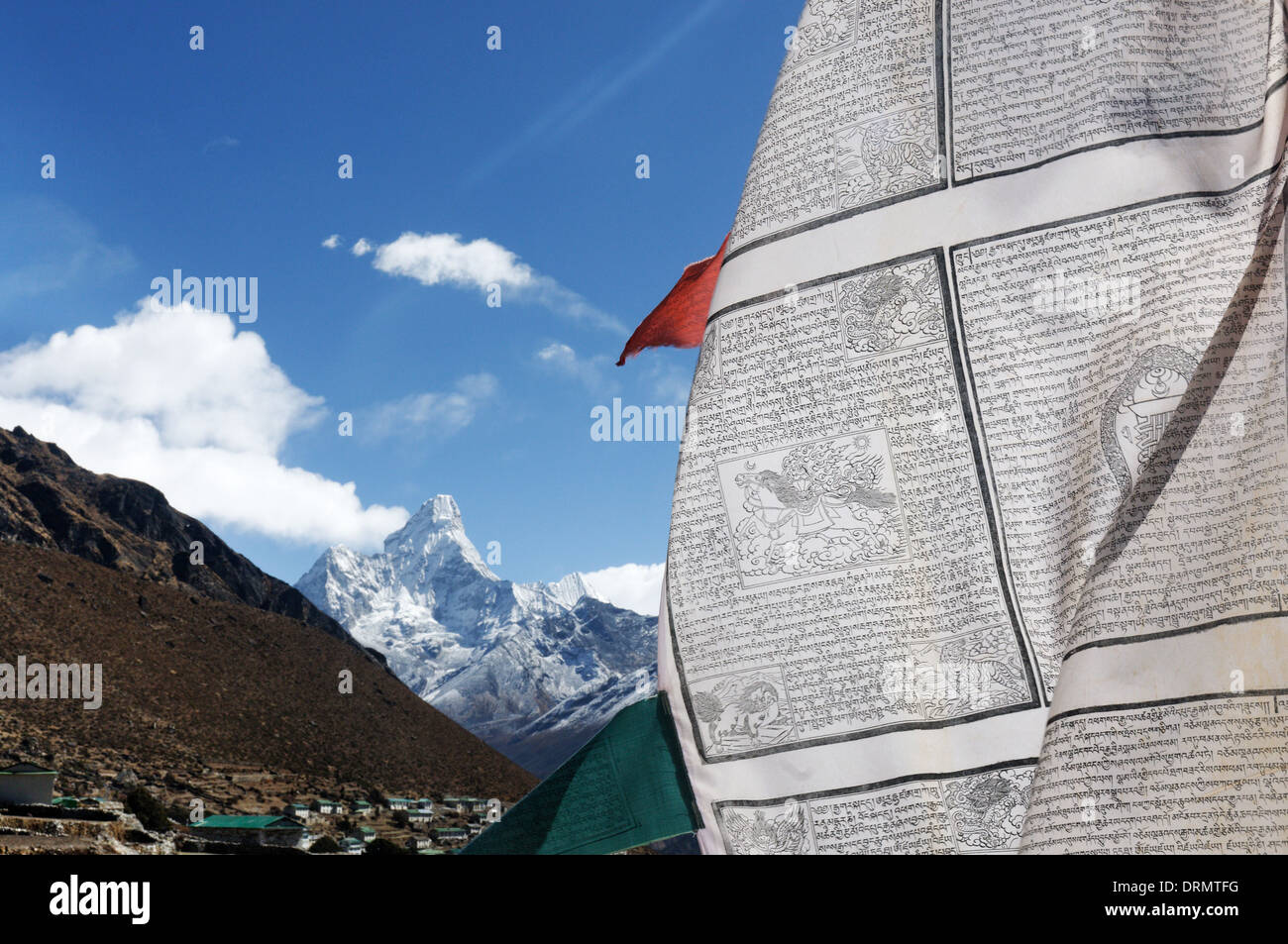 A prayer flag in the village of Khumjung on the everest base camp trek with Ama Dablam beyond Stock Photo