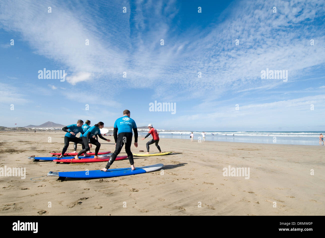 surfing lesson lessons learning to stand up on surf board boards surfboards beach playa famara lanzarote beach beaches canary is Stock Photo