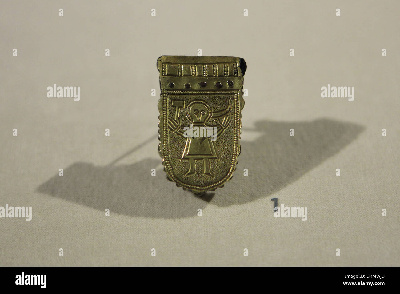 Great Moravian Empire. Gilt belt ferrule decorated with a human figure from the 9th century, found in Mikulcice. Stock Photo