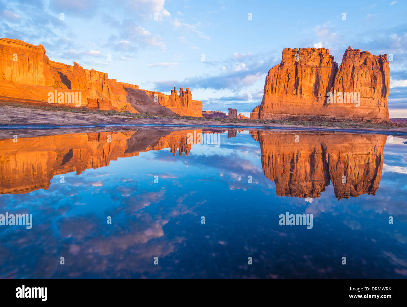 Courthouse Towers reflected in rain pool. Arches National Park, Utah The Organ, Sheep Rock, and Three Gossips Stock Photo