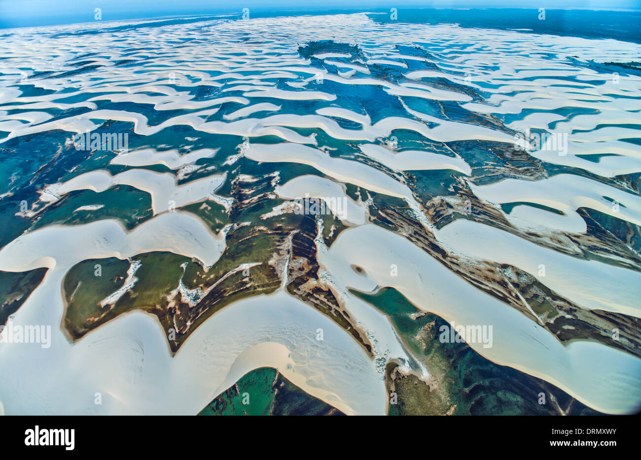 Aerial View of Rainwater ponds trapped in white dunes, Lencois Maranhenses National Park, Brazil, Atlantic Ocean Stock Photo