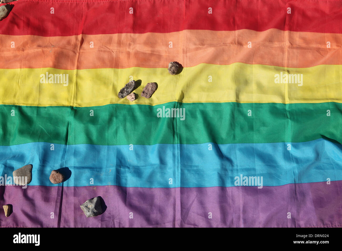 Stones lie on the rainbow flag in remembrance of homosexuals in Buchenwald concentration camp near Weimar, Germany. Stock Photo