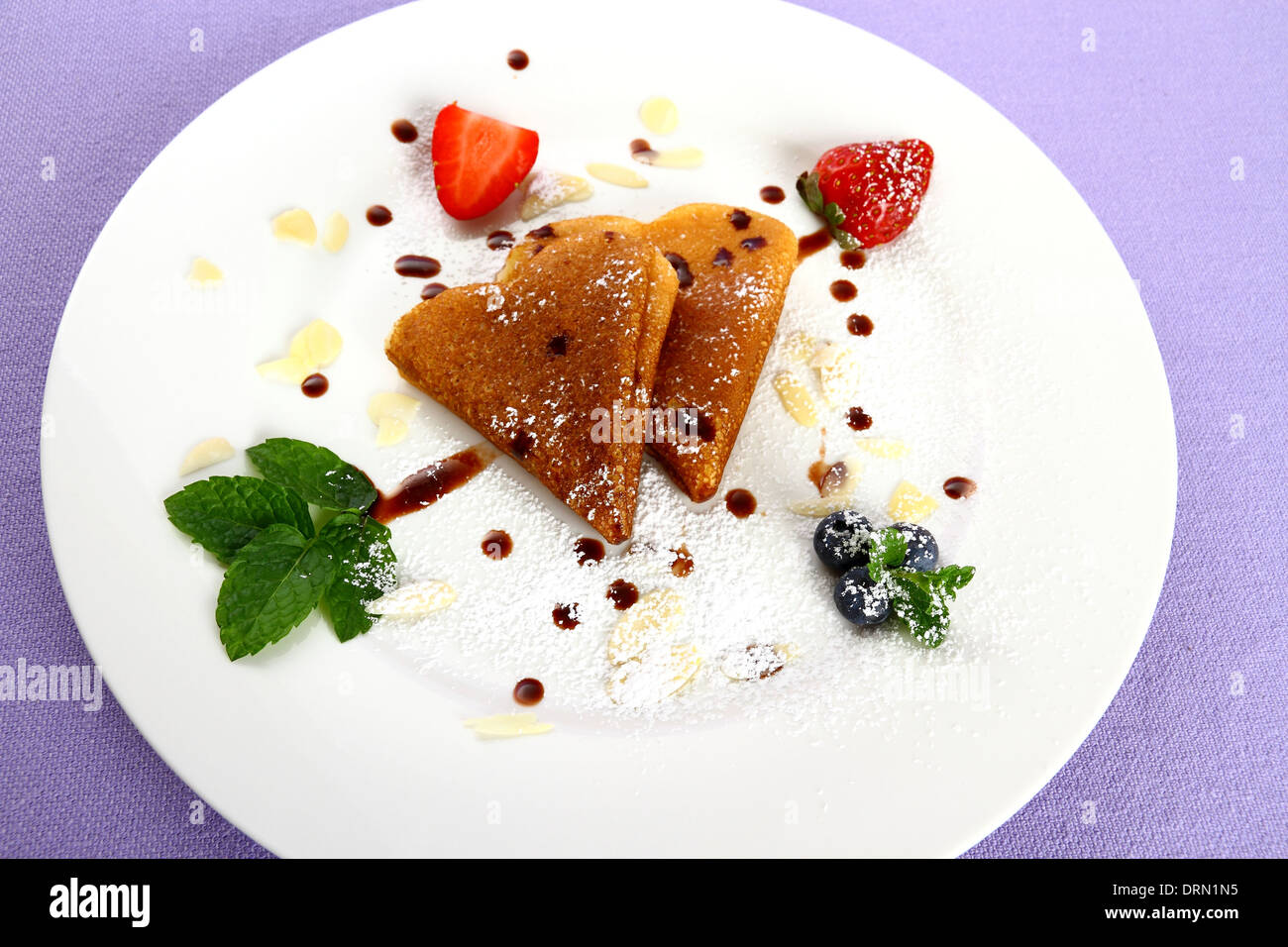 Two pancakes heart and chocolate, strawberry, mint arrow, close up Stock Photo