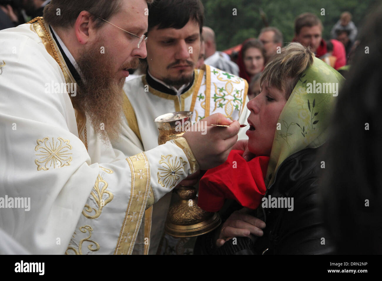 Orthodox believer receives the Eucharist during an orthodox service in honour of Saints Cyril and Methodius in Mikulcice. Stock Photo