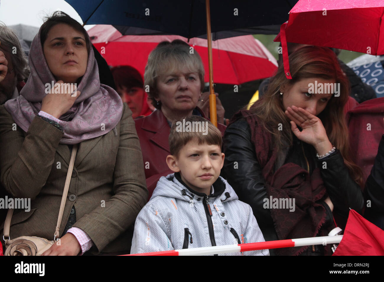 Orthodox believers wearing raincoats attend an orthodox service in honour of Saints Cyril and Methodius in Mikulcice. Stock Photo
