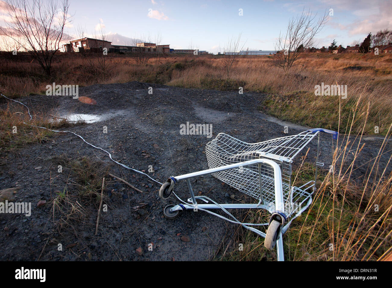 Abandoned shopping trolley on wasteground on the former site of Ollerton Colliery in New Ollerton, Nottinghamshire, England , UK Stock Photo