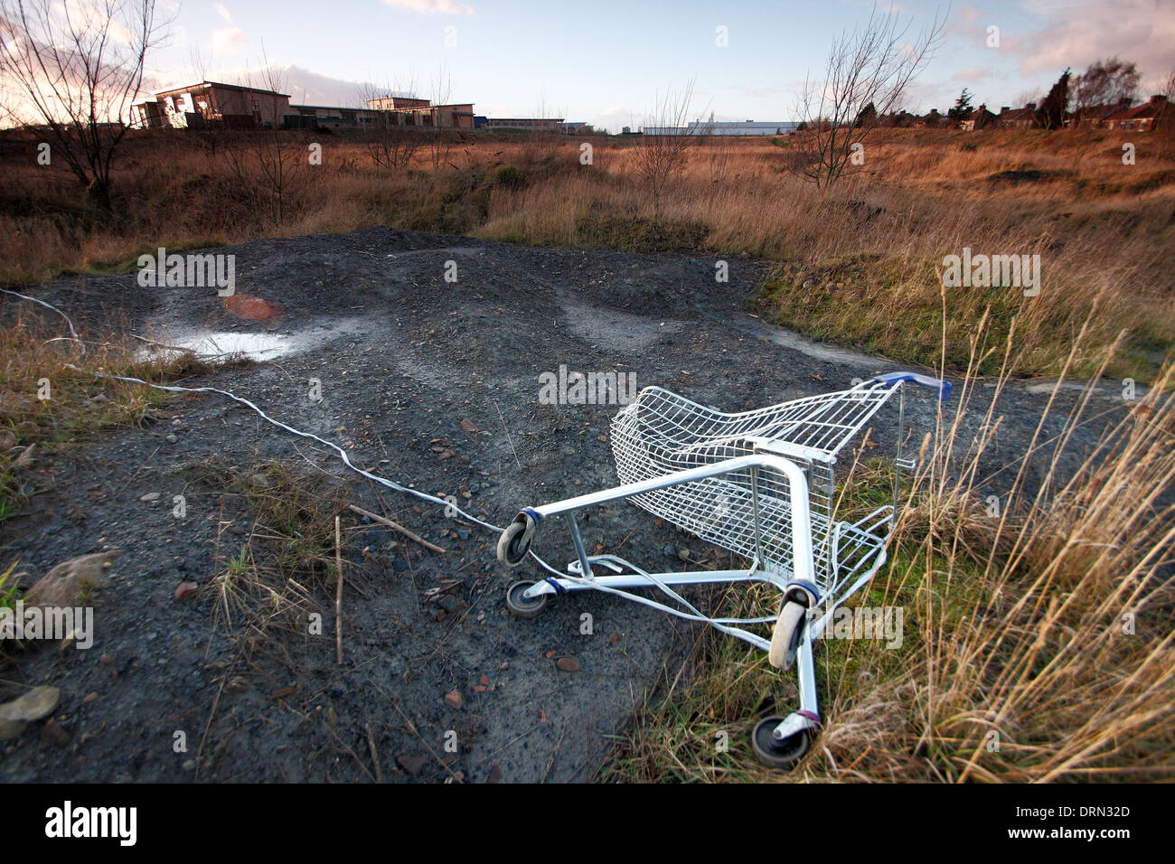 Abandoned shopping trolley on wasteground on the former site of Ollerton Colliery in New Ollerton, Nottinghamshire, England , UK Stock Photo