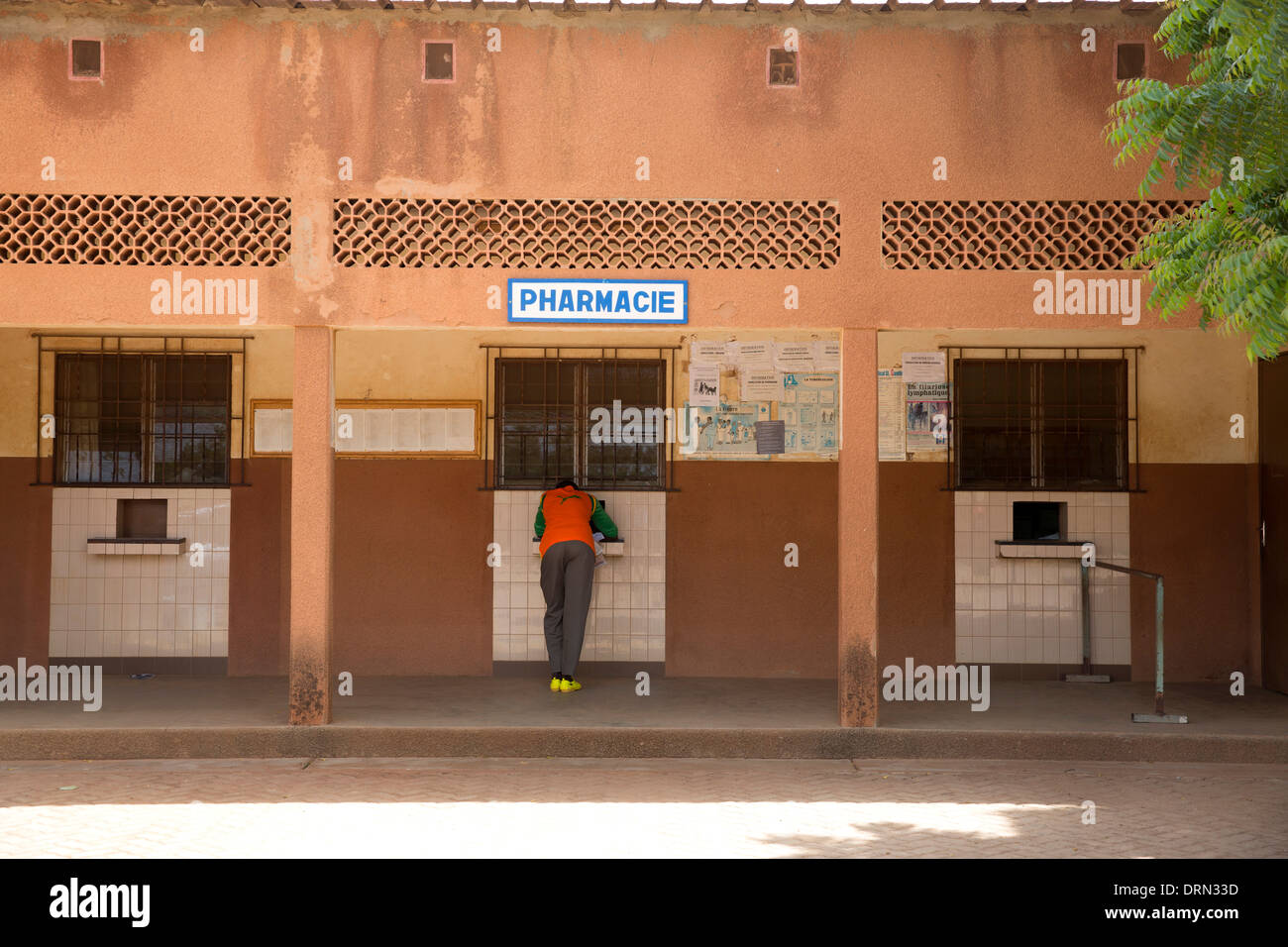 man standing outside pharmacy in main hospital, Ouagadougou, Burkina Faso Stock Photo