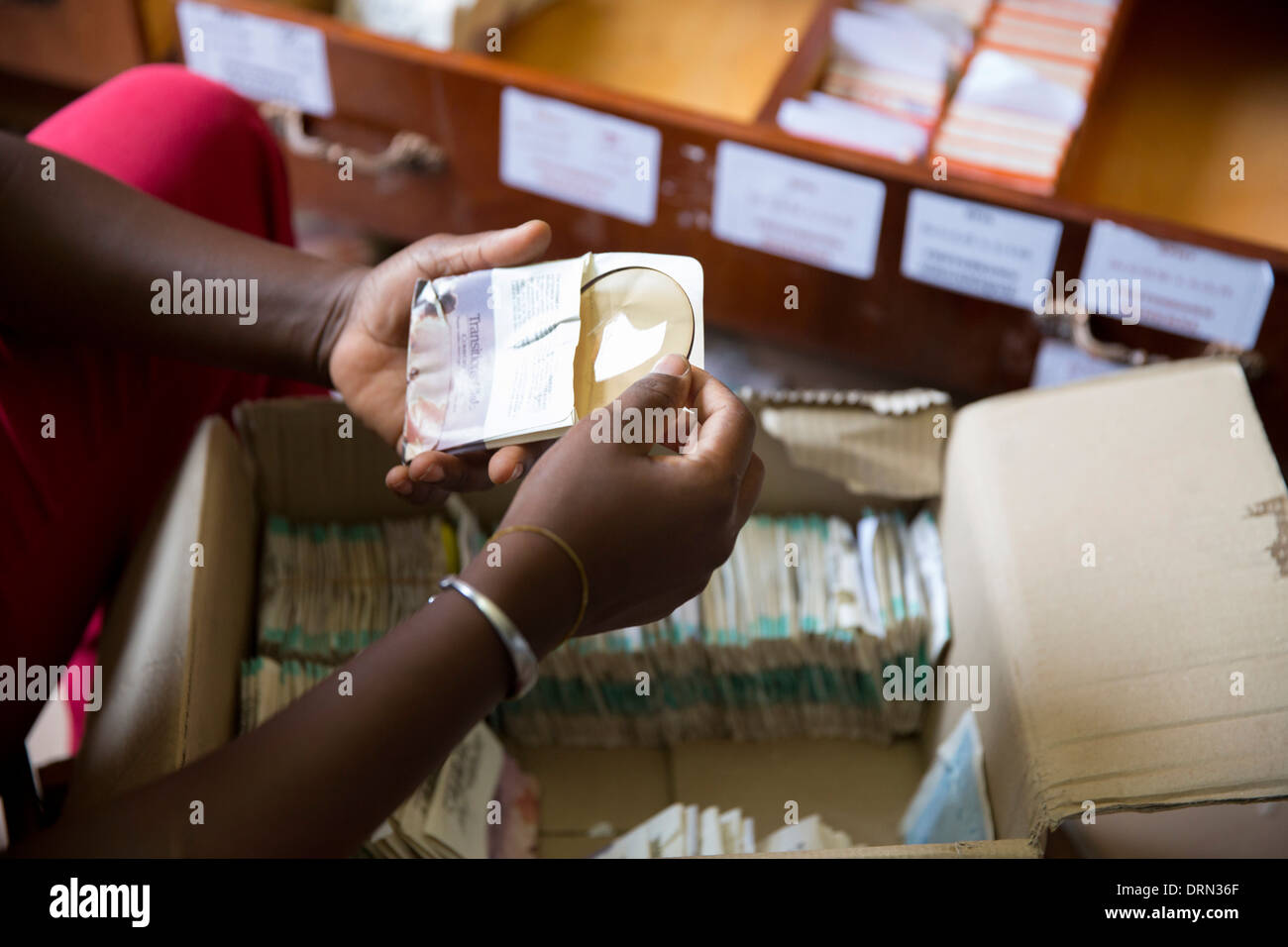 sorting donated glasses and lenses in eye clinic, Ouagadougou, Burkina Faso Stock Photo