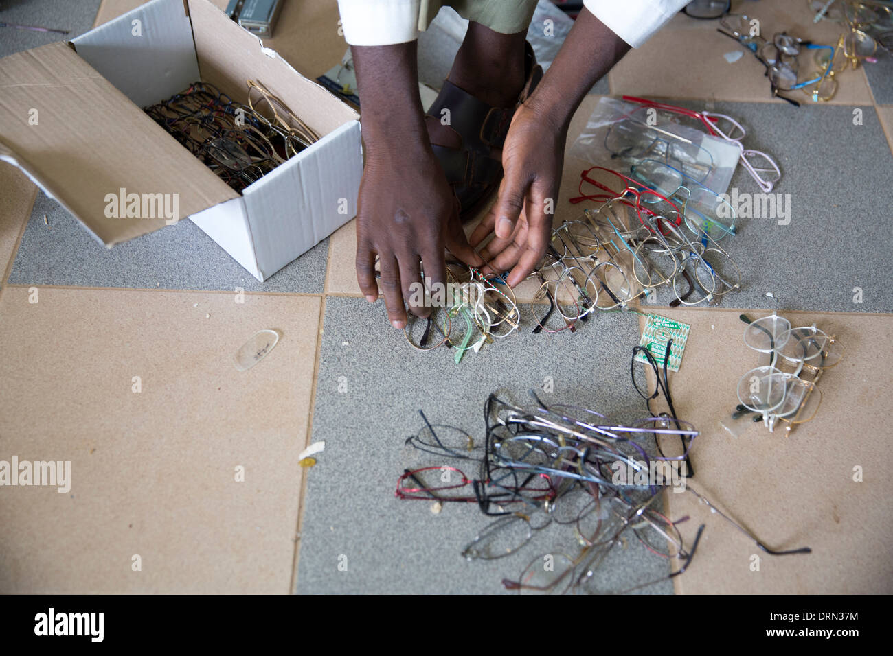 sorting donated glasses and lenses in eye clinic, Ouagadougou, Burkina Faso Stock Photo