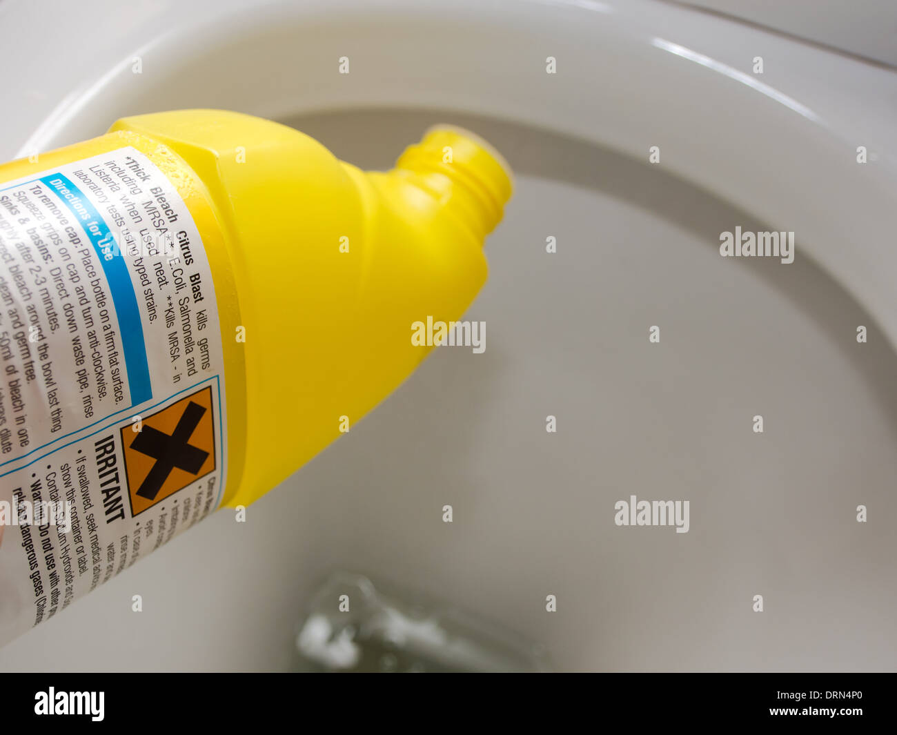 Bleach bottle being used in a toilet bowl Stock Photo Alamy