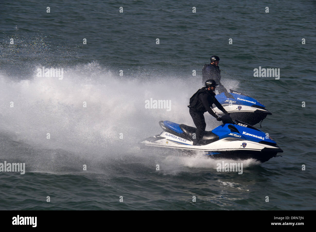 Alameda County police officers on jet skis patrolling during America's Cup race in the San Francisco Bay, California, USA Stock Photo