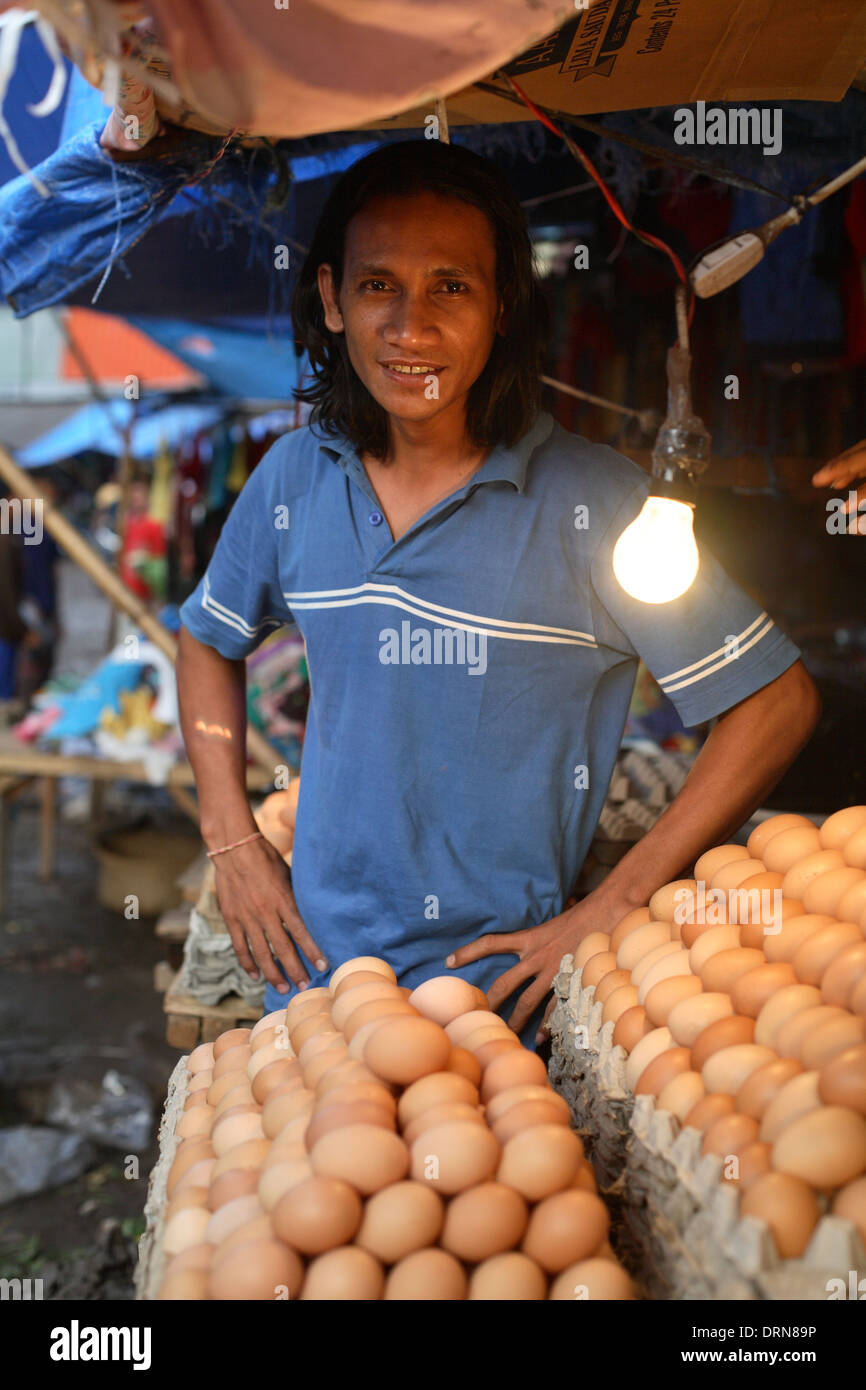 Portrait of smiling Indonesian young man selling eggs at market in Kupang, West Timor, Indonesia Nov 2005 Stock Photo