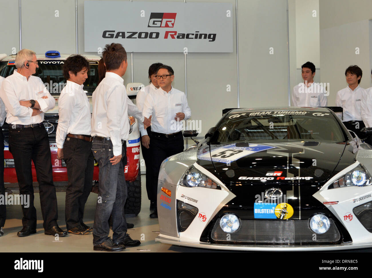 Tokyo, Japan. 30th Jan, 2014. President Akio Toyoda of Japan's Toyota Motor Corp., shakes hands with drivers of its racing team during a presentation of the company's motor sports activities for 2014 in Tokyo. They will include participation in the FIA World Endurance Championship and the Le Mans 24-hour race, the NASCAR racing series and the Super GT and Super Formula championships. Toyoda said its motor sports activities through Lexus Racing and Toyota Racing are aimed to bring more joy to more people through automobiles. Credit:  Natsuki Sakai/AFLO/Alamy Live News Stock Photo