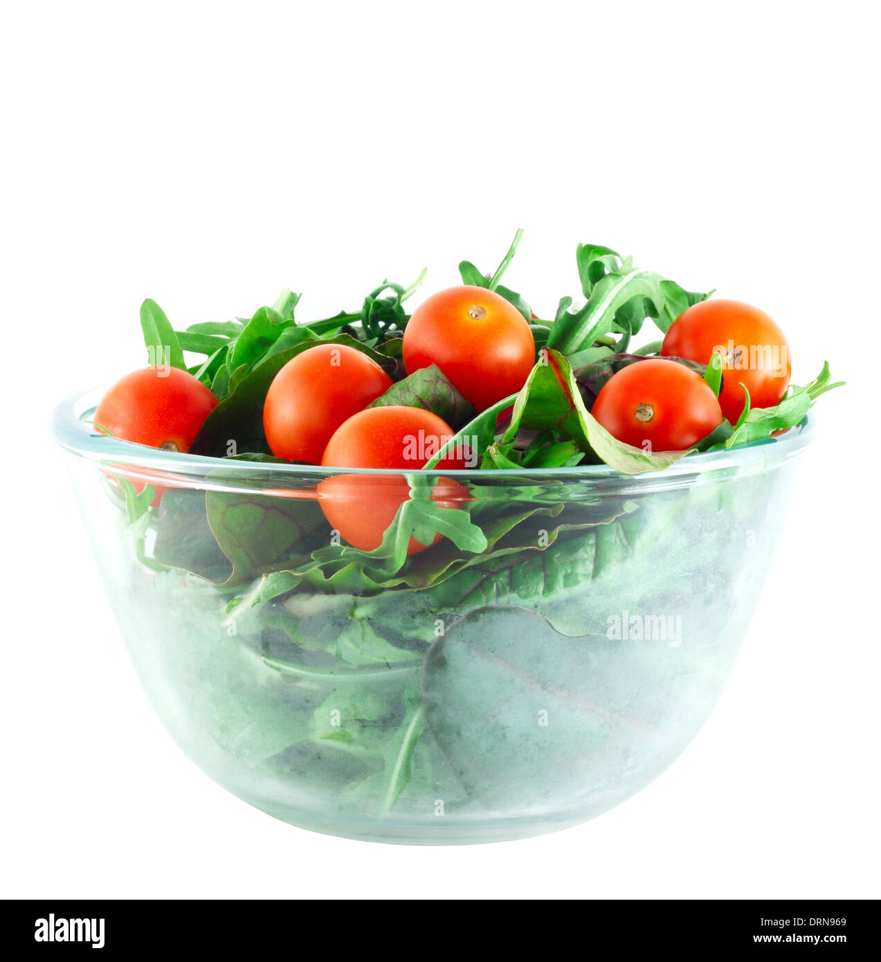 Rucola ,Chard and cherry tomatoes salad in transparent bowl isolated on white Stock Photo