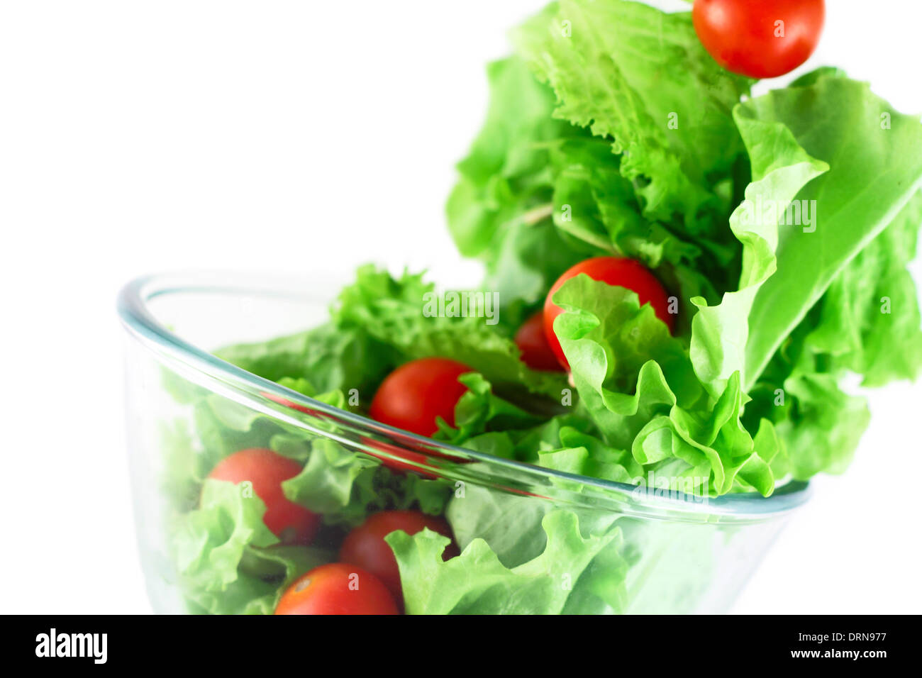 Light lettuce and cherry tomatoes salad closeup isolated on white